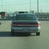 idiot  transports ladder in a car