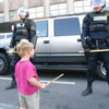 kid with stick agains several policemen