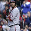 baseball player carries his bat