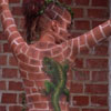 model poses by the brick wall