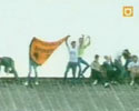 soccer fan falls through the roof and hits ground.