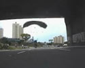 stunts dives and lands under the bridge.