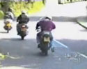 dude knocs his friend down from motorbike.