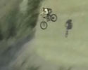 stunt jumps down from mountain on his bike.