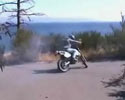 driver slips and his bike flies off the cliff.