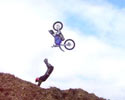 biker tries to perform looping, but lands roughly.