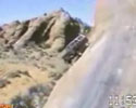 Jeep attempts to drive down steep cliff .