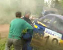 racing car nearly hits a guy standing near road.