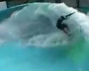 some dude is surfing on simulated wave in pool