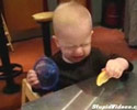 funny baby eating a piece of the lemon